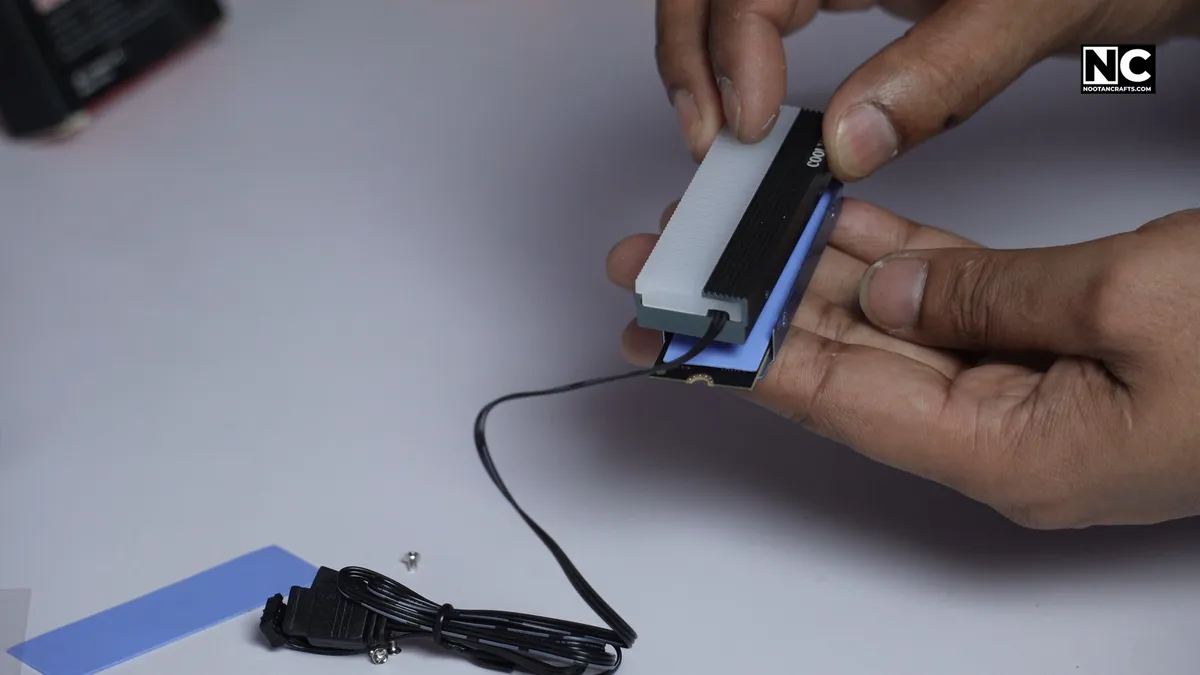 Securing the heatsink bracket onto the NVMe SSD with small screws