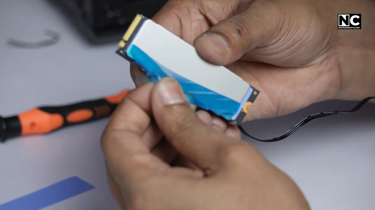 Peeling the protective film off the outer face of an M.2 heatsink