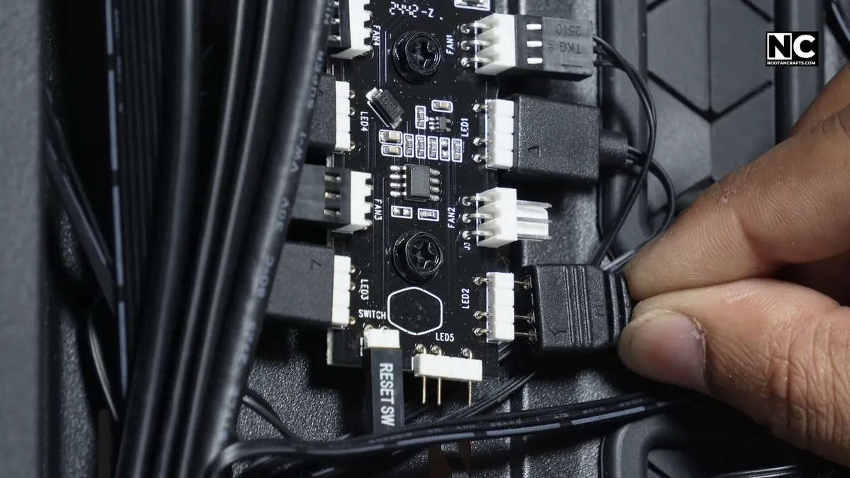 Sliding the heatsink-equipped SSD back into the M.2 slot at an angle