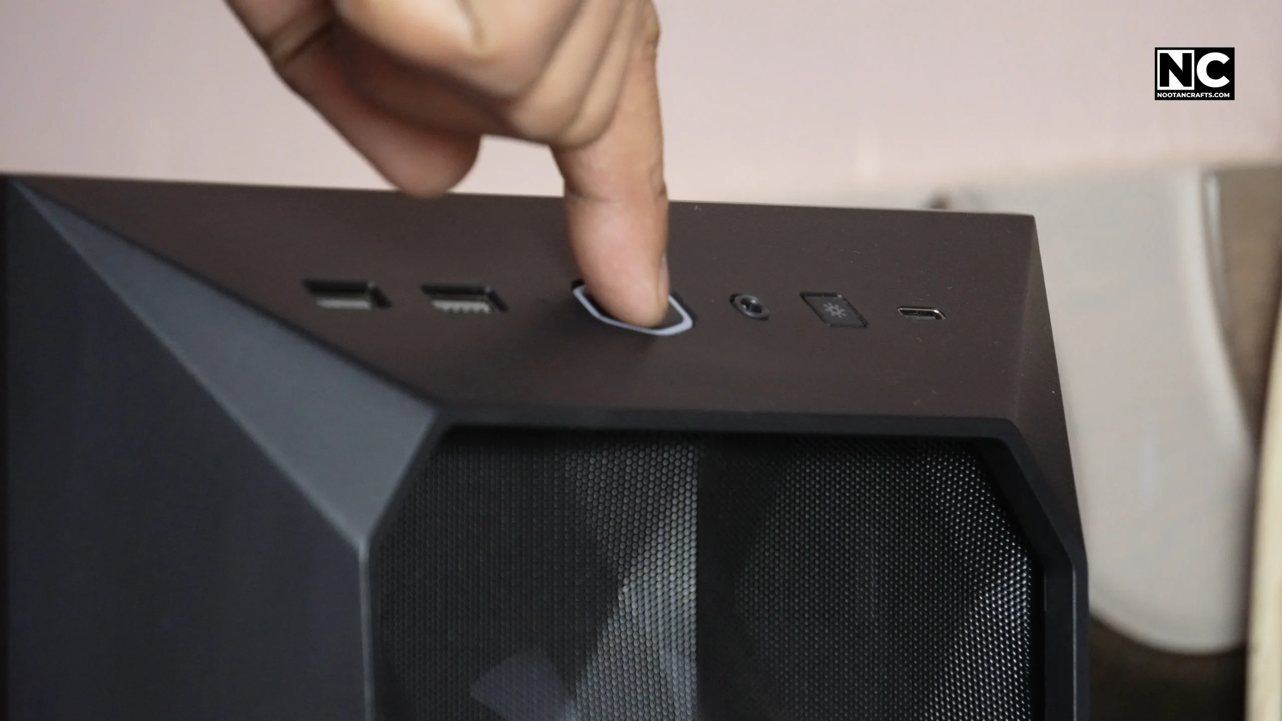 Pressing the case power button to test the newly installed fan